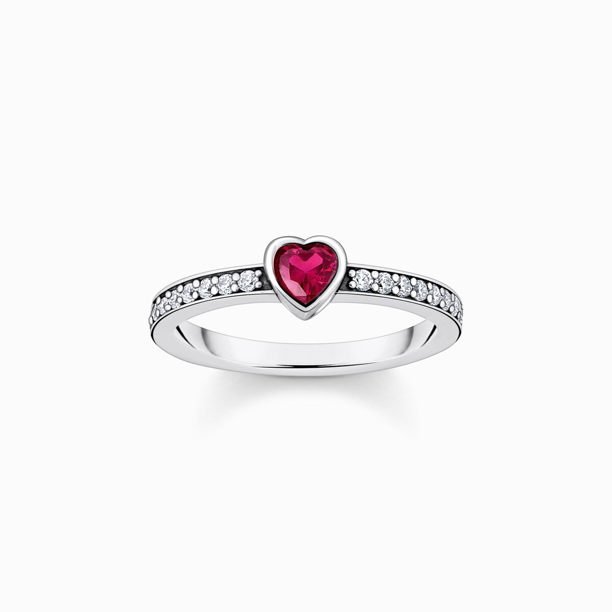 Silver solitaire ring with red heart-shaped stone