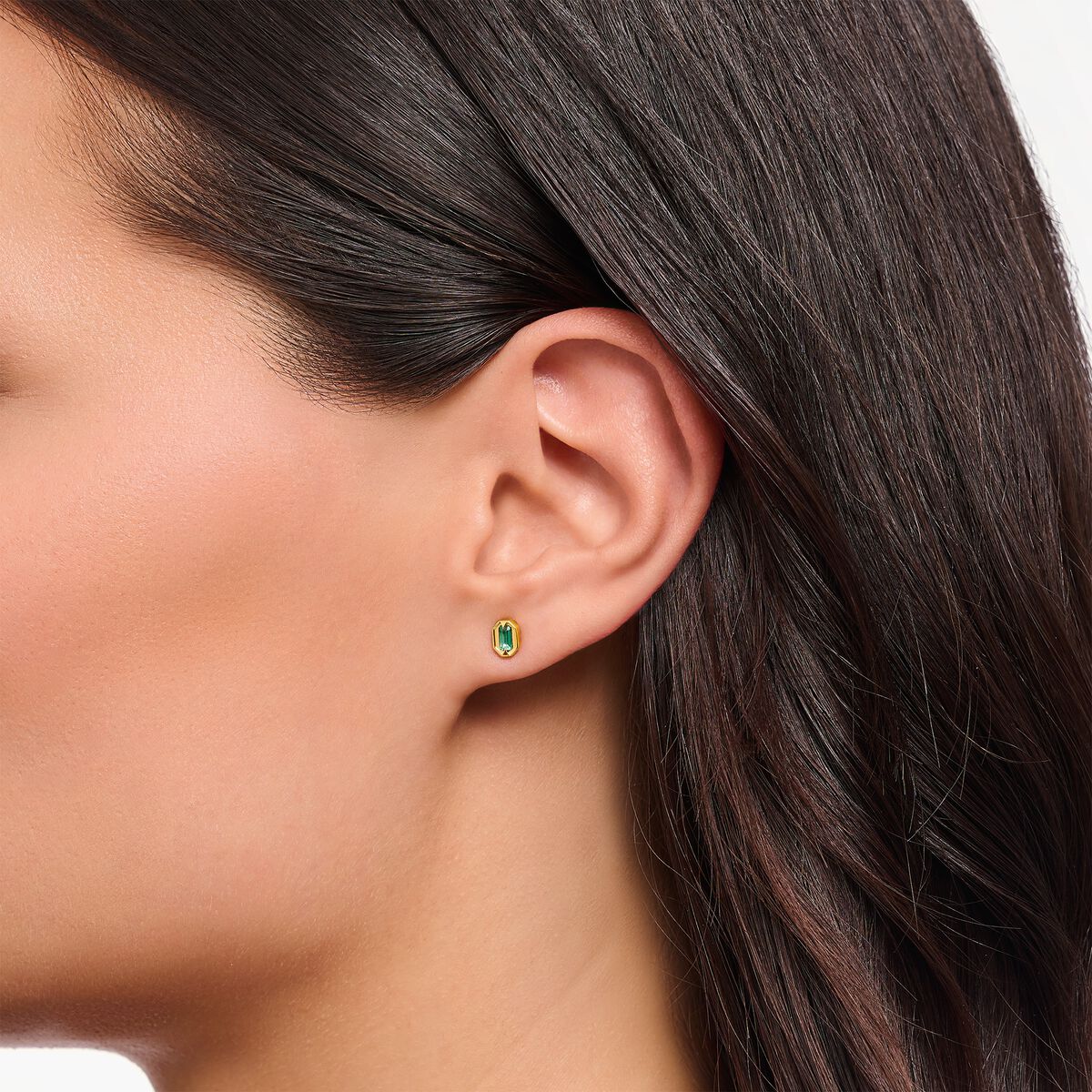 Small yellow-gold plated ear studs with green stones