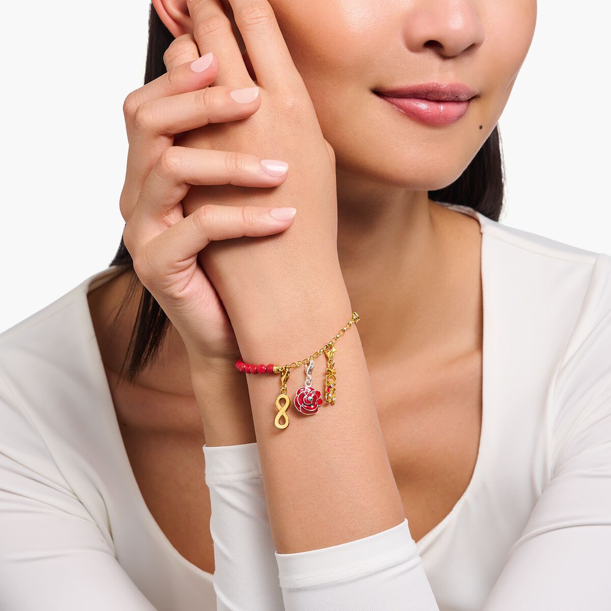 Gold-plated charm bracelet with red beads