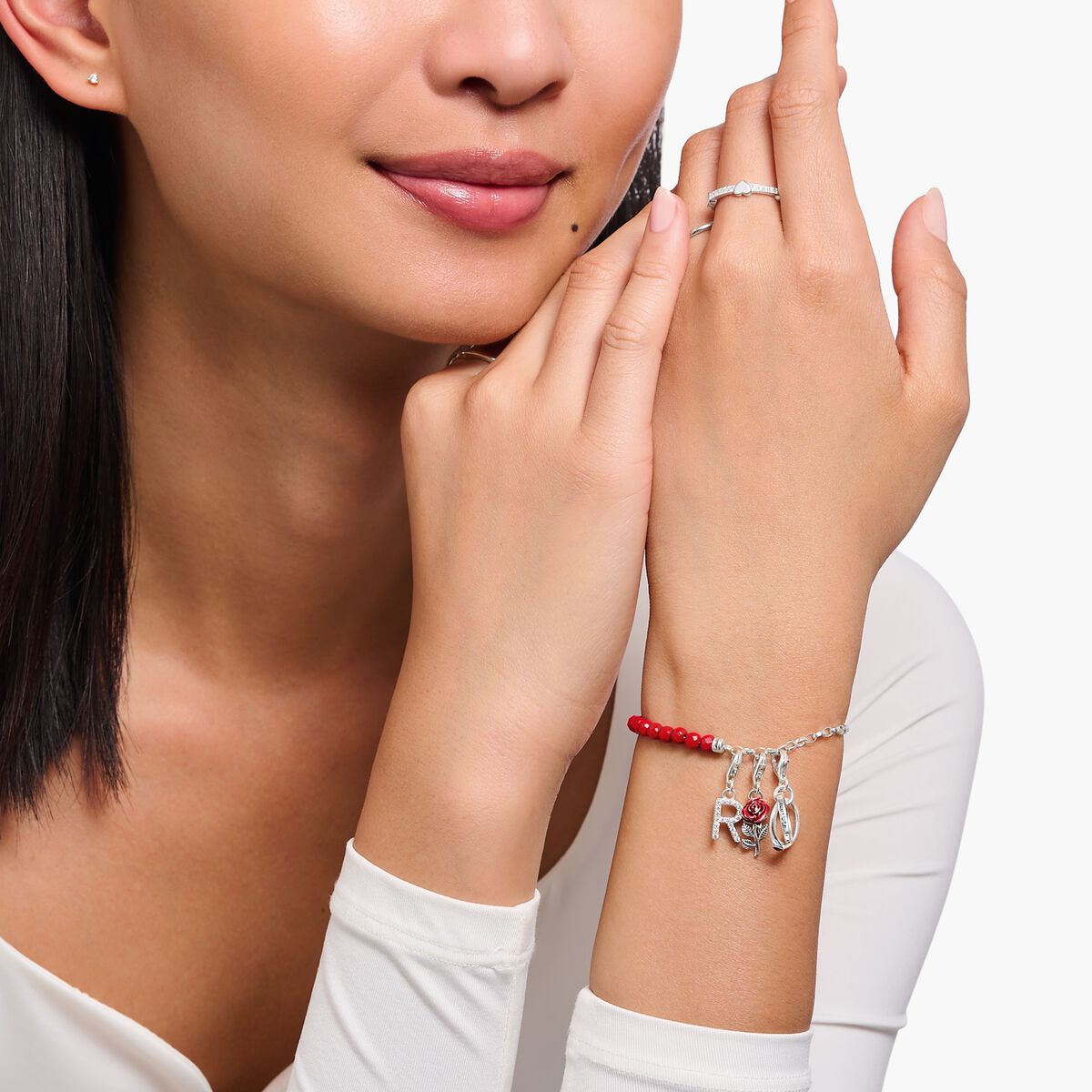 Silver charm bracelet with red beads