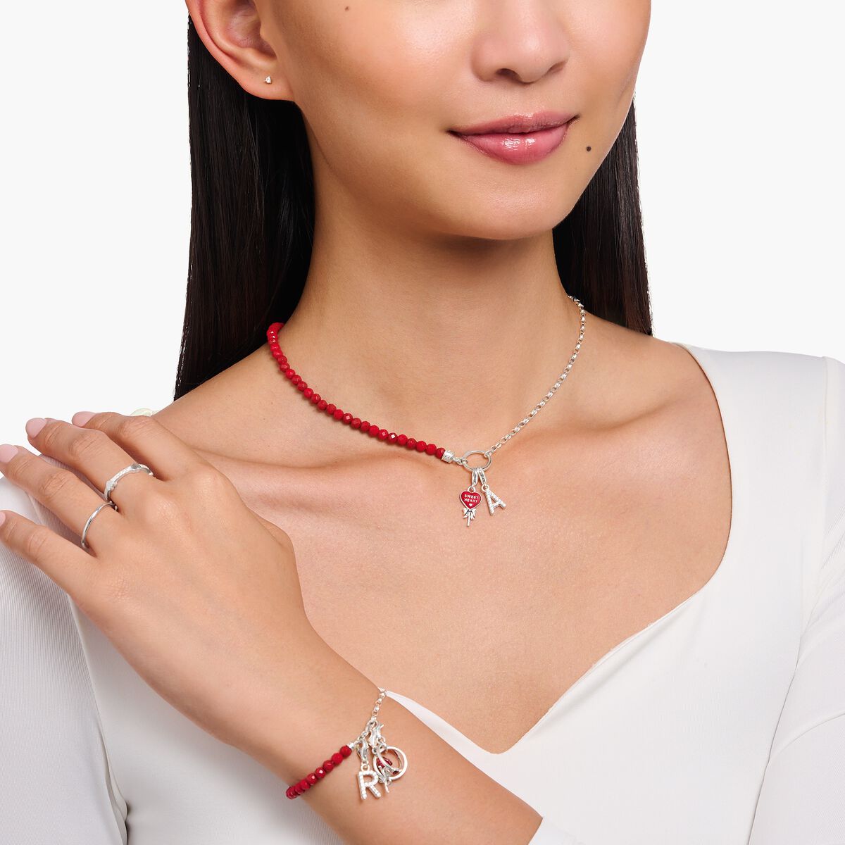 Silver charm necklace with red beads