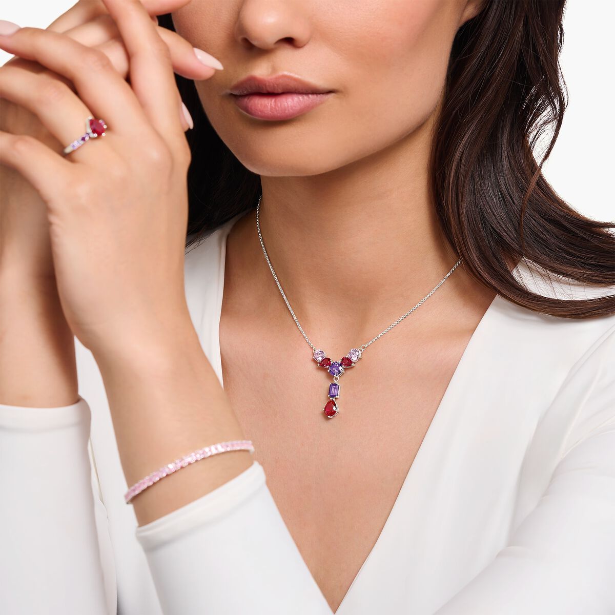 Silver necklace in Y-shape with pink, red and violet zirconia