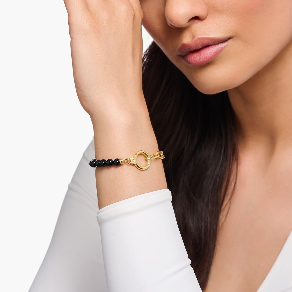 Yellow-gold plated bracelet with onyx beads and white zirconia