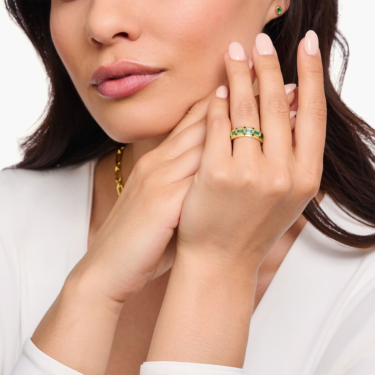Wide gold plated ring in crocodile design with green stones