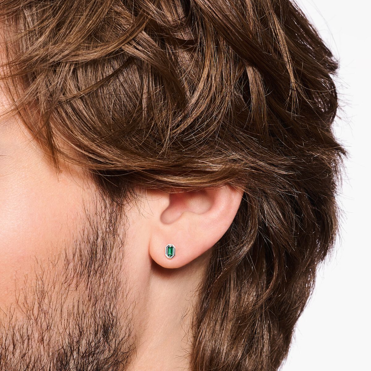 Blackened silver ear studs with crocodile eyes and green stones
