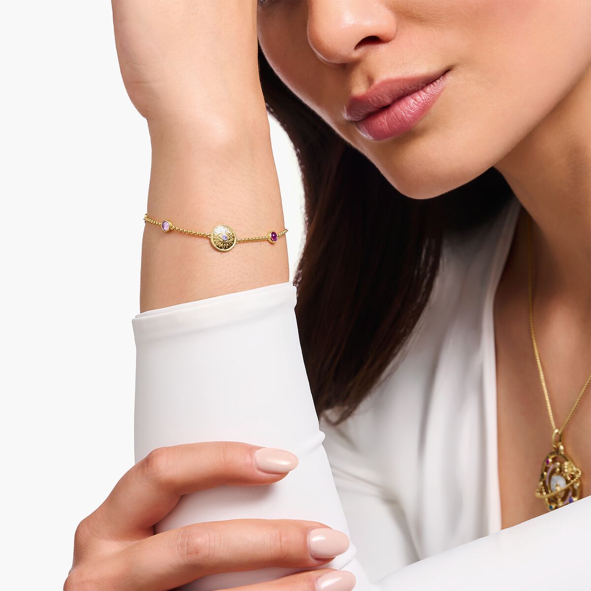 Yellow-gold plated bracelet with a sun coin and various stones